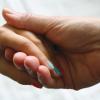 Two hands holding one another
