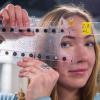 Student holding up soft, flexible device