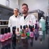 CU Boulder Professor Lupita Montoya and undergraduate student standing behind bottles of nail polish