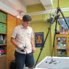 Dimitri Nakassis examining and photographing the pylos tablet