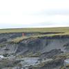 An Alfred Wegener Institute permafrost team inspects a massive thaw slump on the Yedoma coast of the Bykovsky Peninsula.