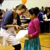 A girl receiving an award during a positive recognition campaign event in Montbello
