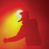Hip-hop performer silhouetted against stage light (Photo: Gennadiy Kravchenko/istockphoto.com))