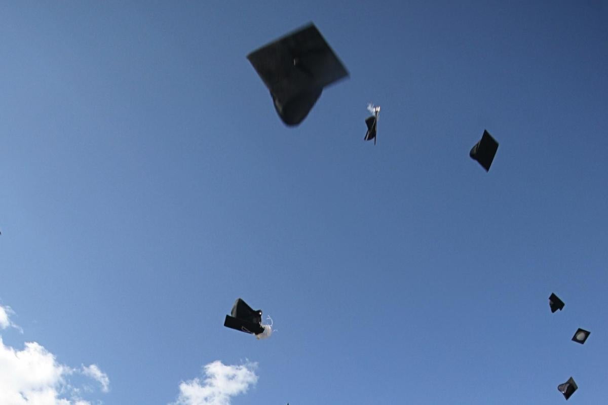 Picture of graduation hats thrown in the sky