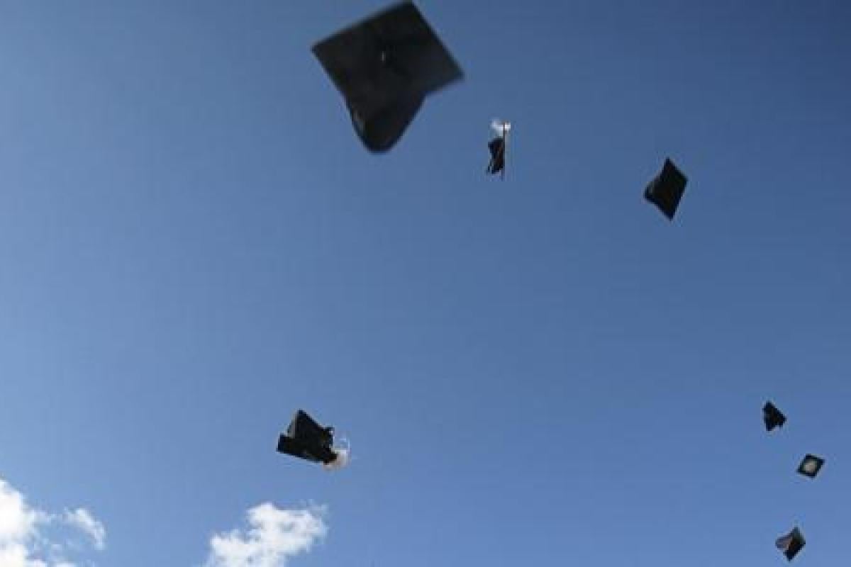 Graduation hats thrown in the sky