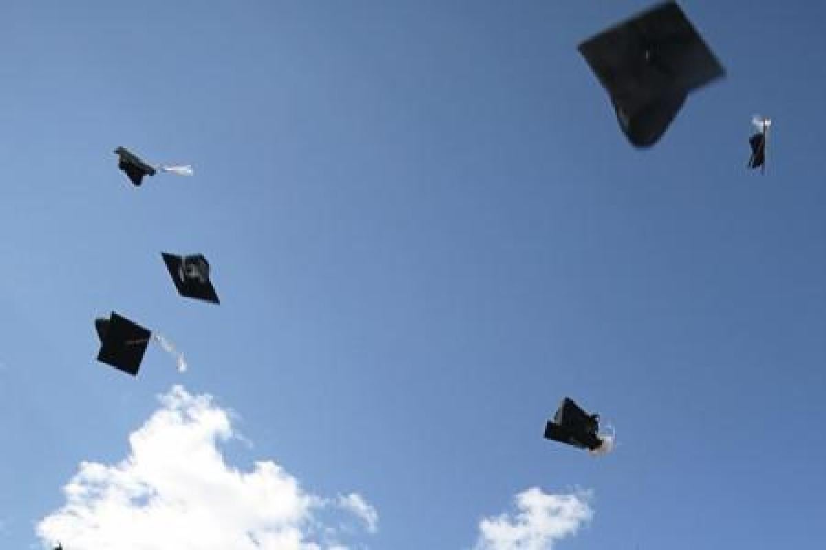 Graduation hats thrown in the sky