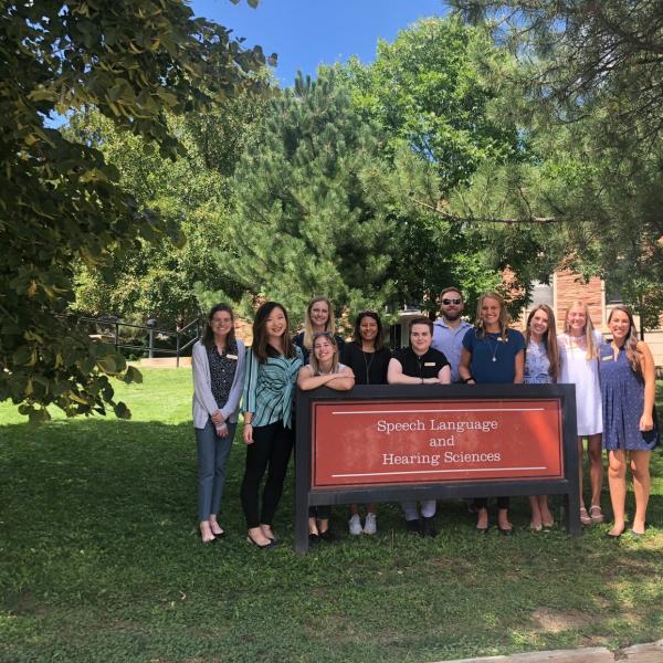 Class of 2022 AuD Cohort in front of the SLHS sign outside the SLHS building