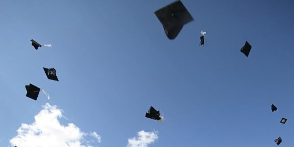 Picture of graduation hats thrown in the sky