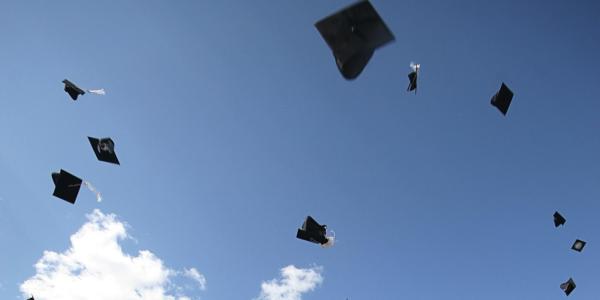 Picture of graduation hats thrown in the sky
