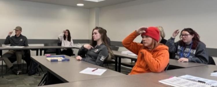Students in classroom learning how to sign in ASL
