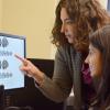 Clinician and teacher looking at brain results on a computer.