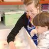 Clinician and client playing in a water tub