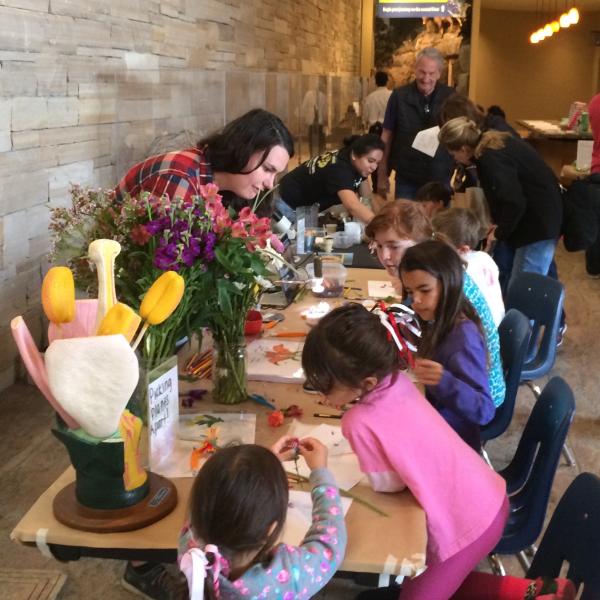 Chelsea teaching about flowers at CU South Family Fun Day, 2017