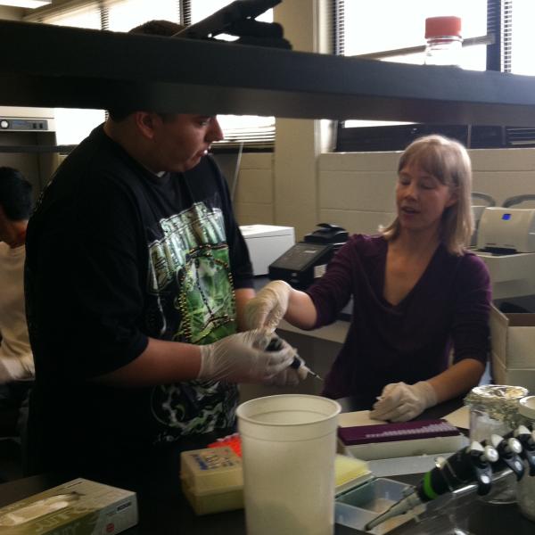 Stacey supervises pipetting practice. Northeast Upward Bound Program, June 21, 2011