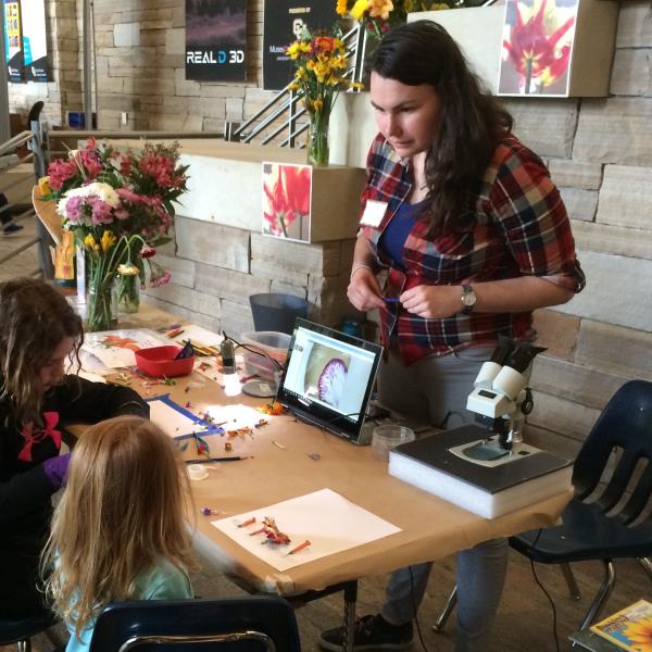 Chelsea teaching about flowers at CU South Family Fun Day, 2017