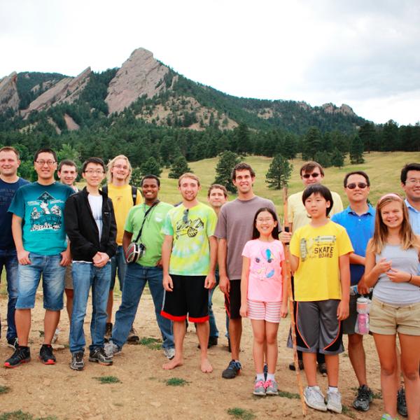 everybody is smiling before climbing up the hill during a group hike in fall 2014