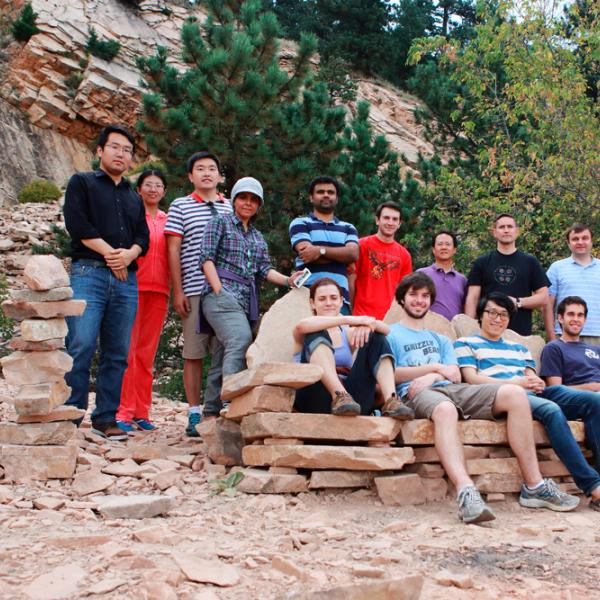 members resting at the top during a group hike in summer 2015