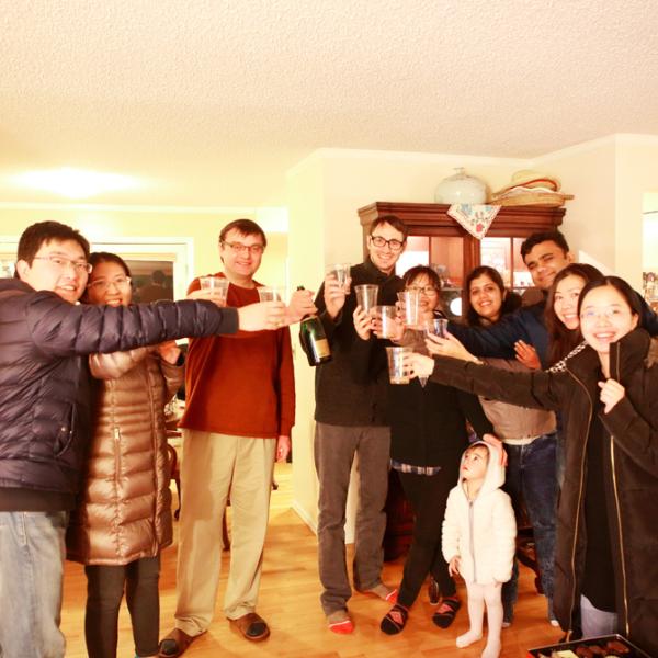 members cheering at a holiday party in winter 2016