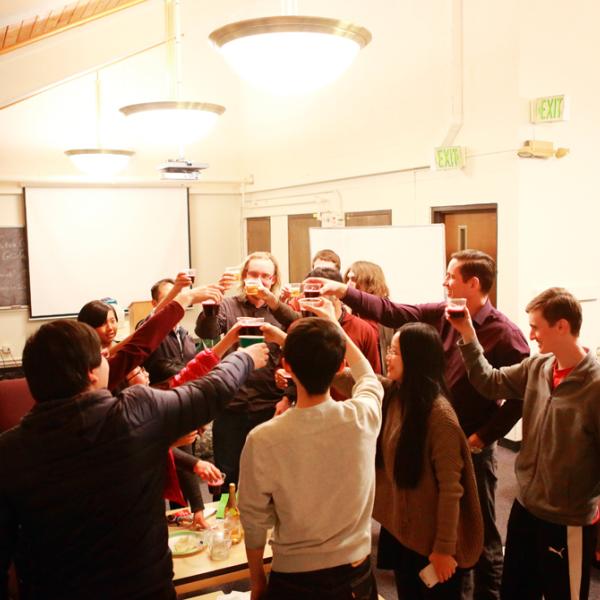 cheers during a holiday party in fall 2015 on the top of the Gamow tower