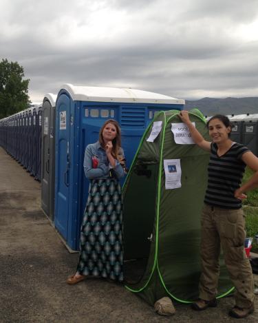 Researchers standing outside a poop collection station at a race