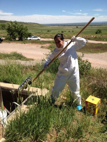 Researcher in Tyvex colllecting park sludge