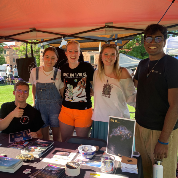 A group of student ambassadors posing at the Be Involved Fair booth