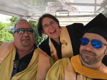 Frazier volunteers each year to serve as a staff Marshal during CU Boulder’s annual commencement ceremony at Folsom Field. In this photo, she is pictured celebrating our graduates with golf cart Marshals and CU colleagues Ben Neeser, right, and Steve Pflipsen on the left.