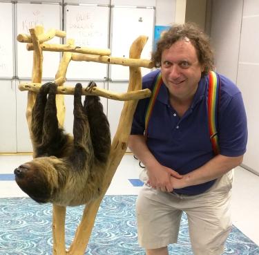 Vic Goldberg posing with the resident sloth at the Denver Aquarium.