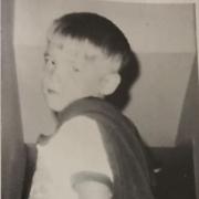 Pat as a kid dressed as a superhero