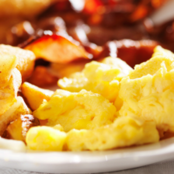 plate of scrambled eggs, potatoes and strawberries