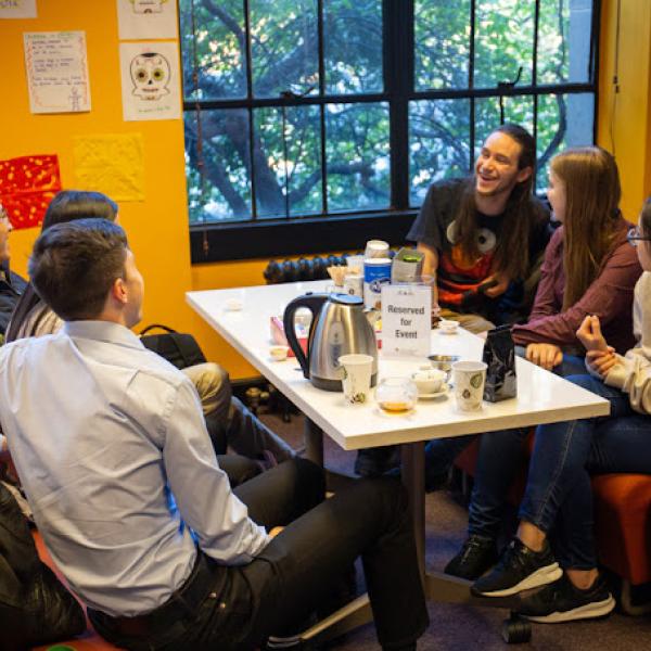 Group of people conversing around a table