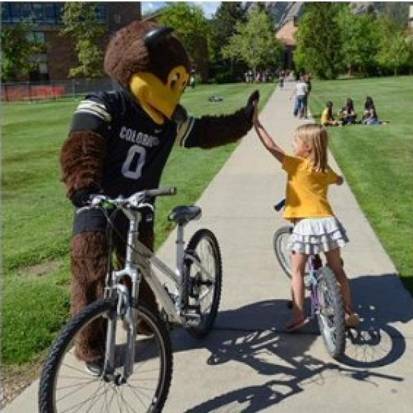 Chip and girl on bike hi-fiving