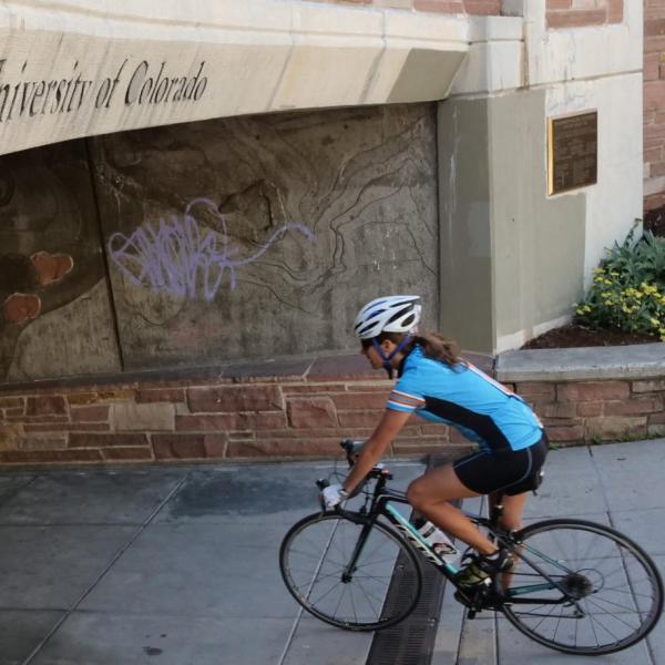 Woman riding bicycle on campus