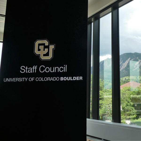 Staff Council banner adjacent to window overlooking flatirons