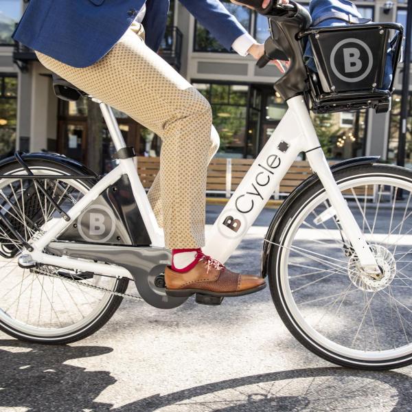 Businessperson riding a B-Cycle