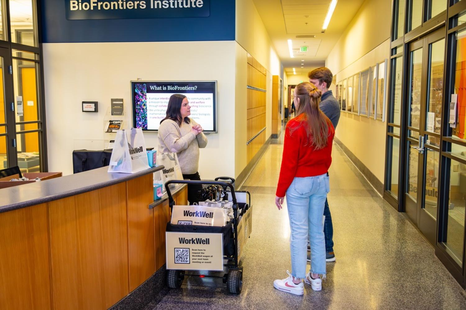 employees with a wagon arriving to a department check-in counter