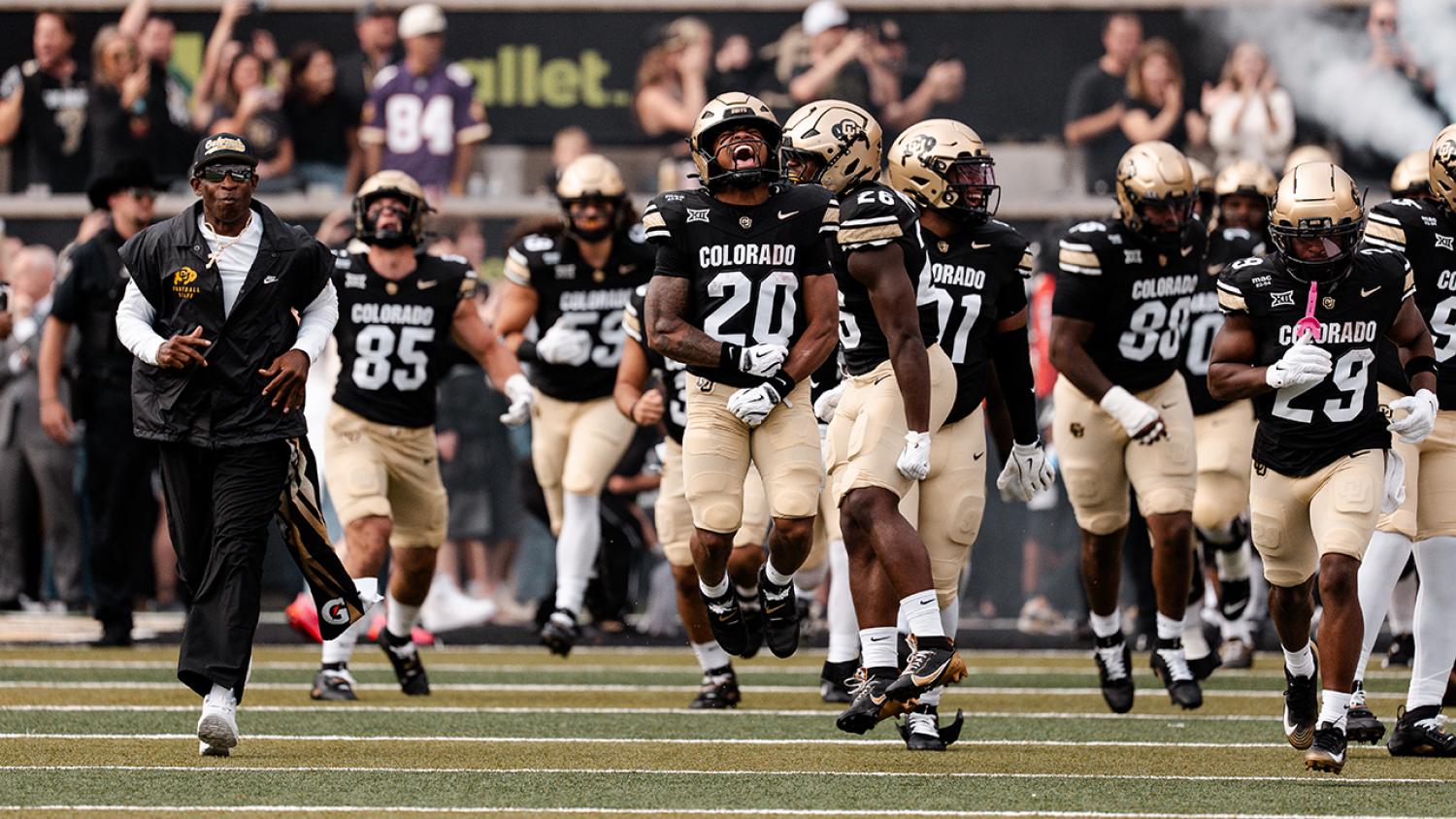 CU Football players on field in uniform