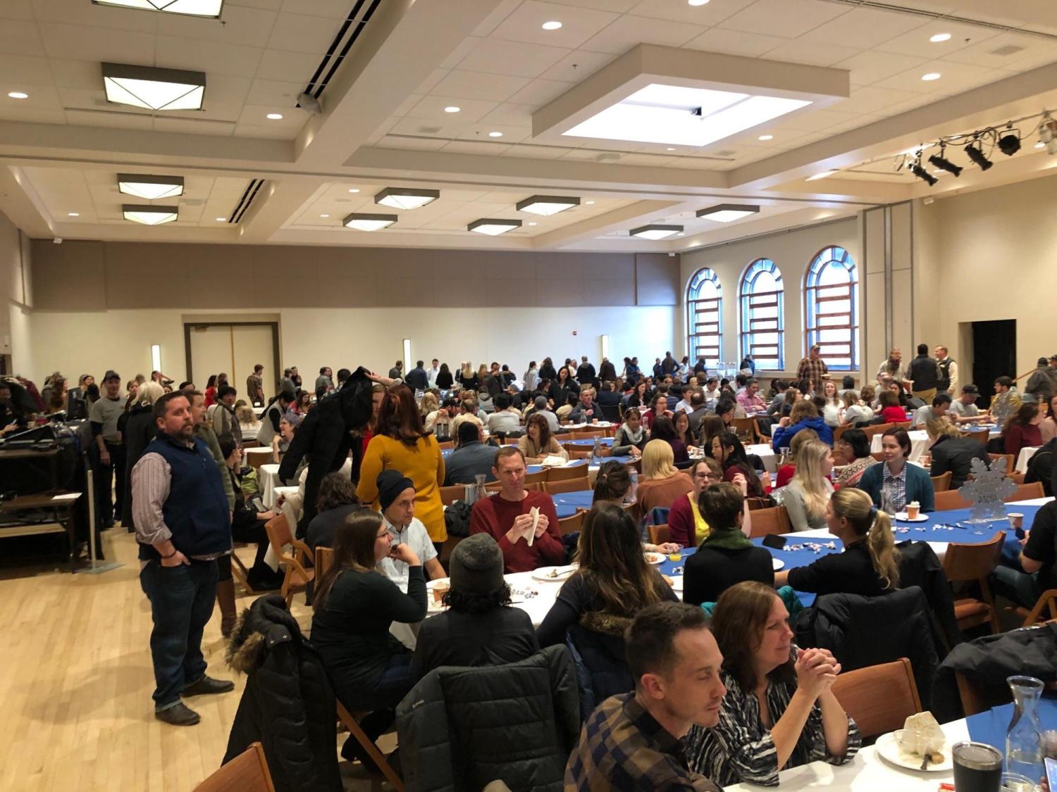 Hundreds of staff in Glenn Miller Ballroom sitting at long tables eating breakfast