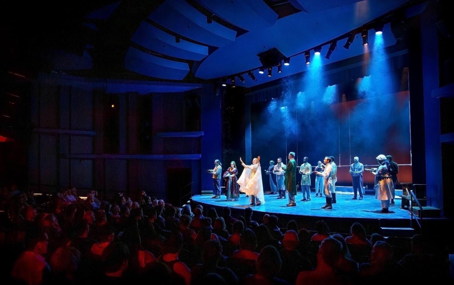 Blue lit stage with performers