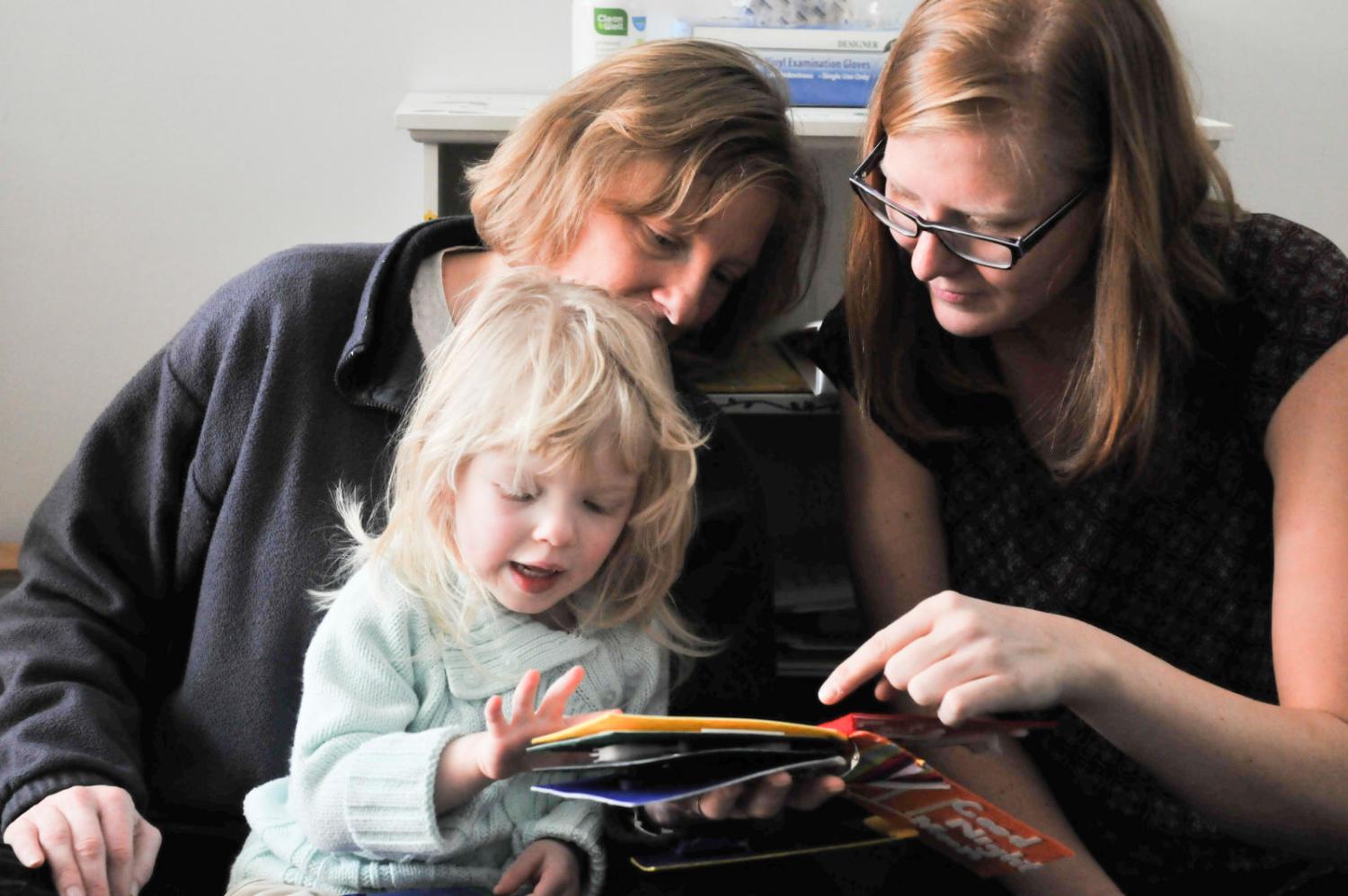Child and two women reading