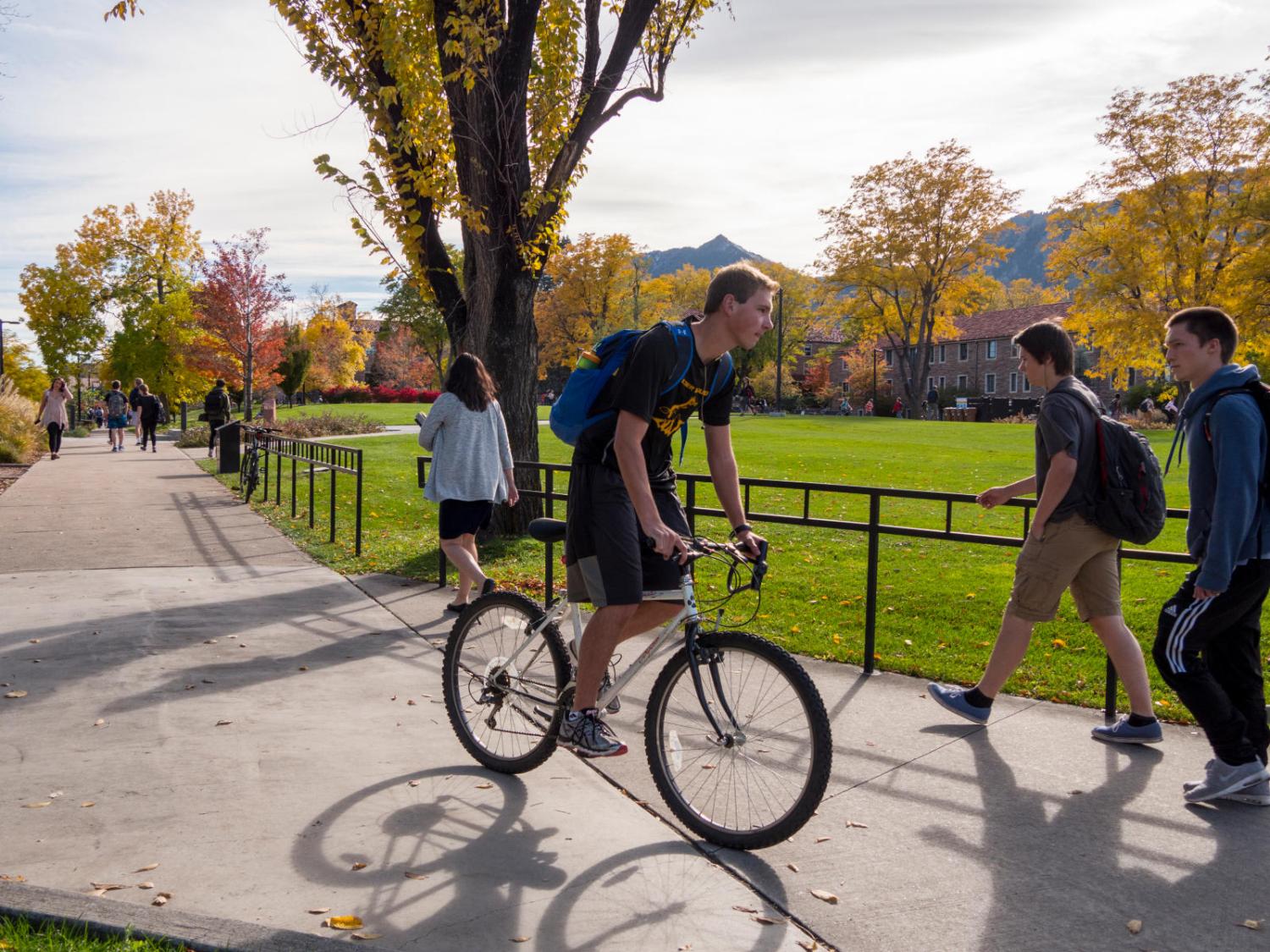 Student riding his bike on campus