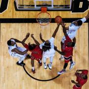 Overhead view of CU basketball players an opponents around the net