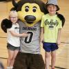 two kids smiling with chip in gym