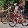 Two people biking around boulder campus