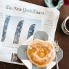 newspaper with a cup of coffee on a table