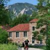 campus image with flatirons and students riding bikes