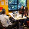 Group of people conversing around a table