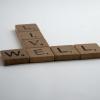 Scrabble tiles spelling out "Live Well"
