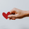 Hand holding red heart