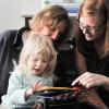 Child and two women reading